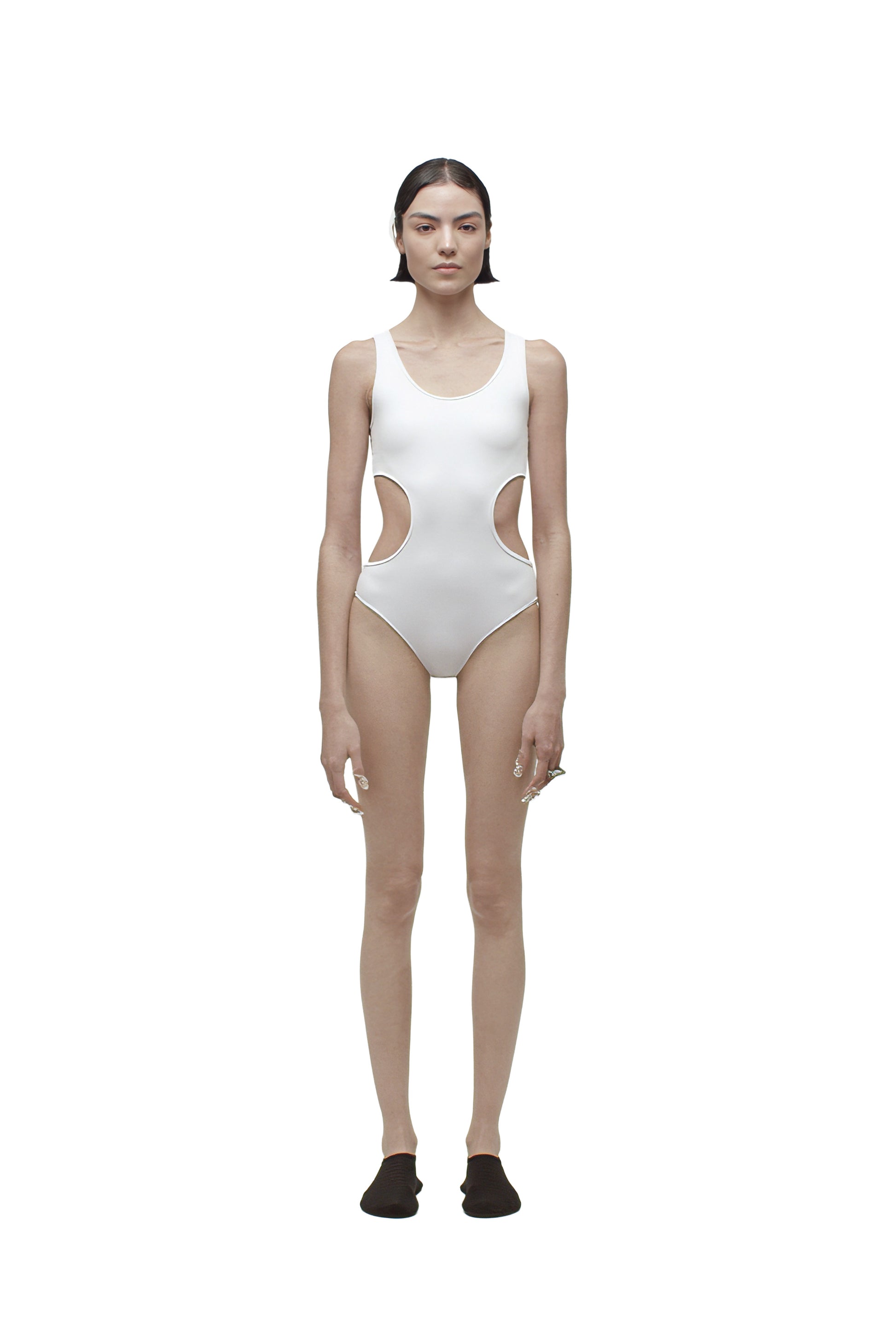 Person wearing a white swimsuit with cut-out design on a white background